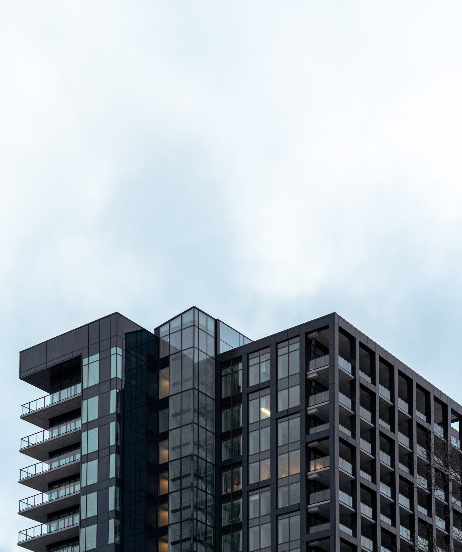 Modern multistage house exterior under cloudy sky in city